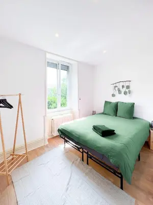 Un ou plusieurs lits dans un hébergement de l'établissement Appart'Hôtel Le Jaurès - Jardin privé et Netflix