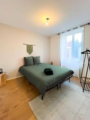 Un ou plusieurs lits dans un hébergement de l'établissement Appart'Hôtel Le Jaurès - Jardin privé et Netflix