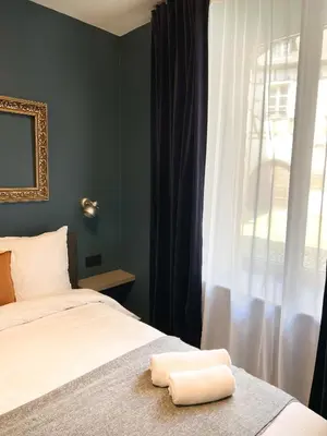 Un ou plusieurs lits dans un hébergement de l'établissement Le Baumann Concept: Appartement de Charme dans un Monument Historique