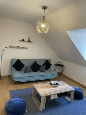 Coin salon dans l'établissement Joli appartement avec place de parking Privé