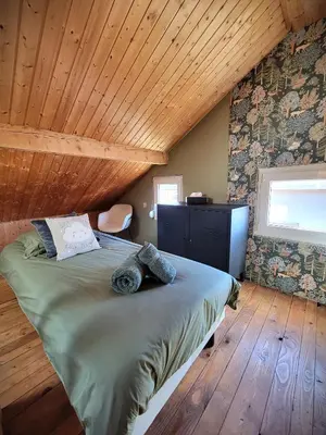 Un ou plusieurs lits dans un hébergement de l'établissement Maison Les Planches
