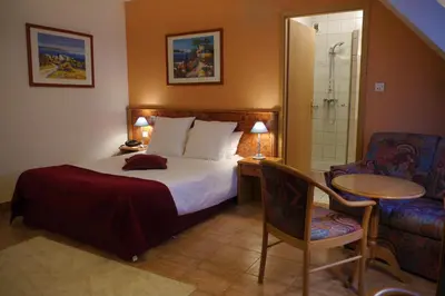 Un ou plusieurs lits dans un hébergement de l'établissement Hôtel sud alsace