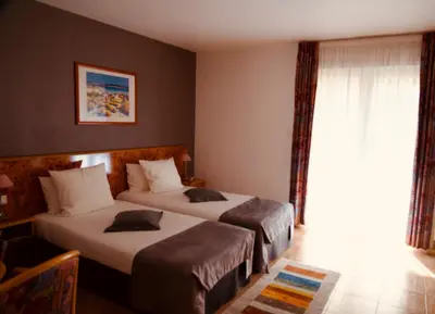 Un ou plusieurs lits dans un hébergement de l'établissement Hôtel sud alsace