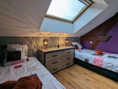 Un ou plusieurs lits dans un hébergement de l'établissement Maison Gite Le Bressaud