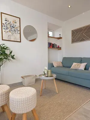 Coin salon dans l'établissement Appartement Les Géraniums