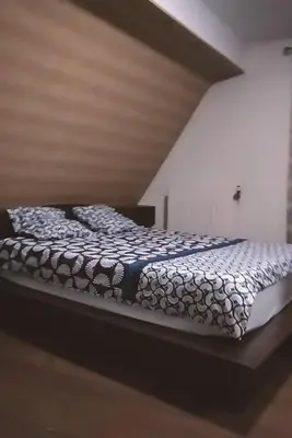 Un ou plusieurs lits dans un hébergement de l'établissement Appartement au pied du château