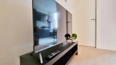 Télévision ou salle de divertissement dans l'établissement La Résidence Évasion 1 - Original - Gare - Wifi - Relax BNB