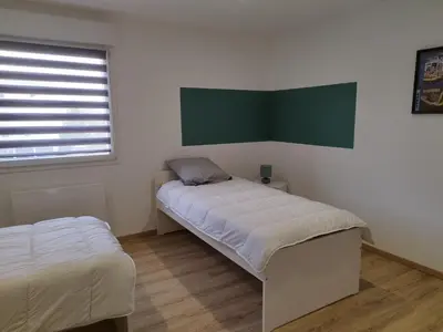 Un ou plusieurs lits dans un hébergement de l'établissement Gîte l'harmonie I