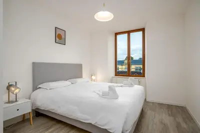 Un ou plusieurs lits dans un hébergement de l'établissement Le 10-GregIMMO-Appart'Hôtel