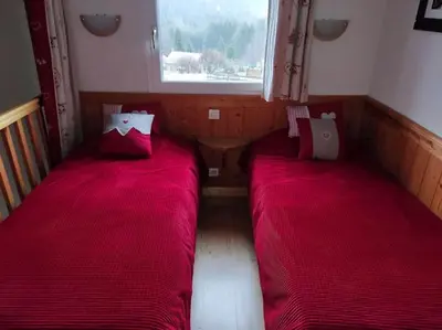 Un ou plusieurs lits dans un hébergement de l'établissement Le Chalet du Bucheron