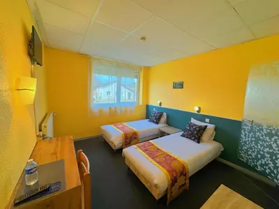 Un ou plusieurs lits dans un hébergement de l'établissement Hotel Le Ronchamp