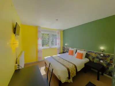 Un ou plusieurs lits dans un hébergement de l'établissement Hotel Le Ronchamp