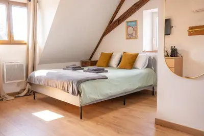 Un ou plusieurs lits dans un hébergement de l'établissement Chambre Rose des Vents