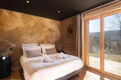 Un ou plusieurs lits dans un hébergement de l'établissement Chalet Tharkey, luxueux au coeur des sapins