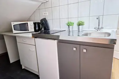 Cuisine ou kitchenette dans l'établissement Petit Loft Centre Ville Historique proche GARE TGV