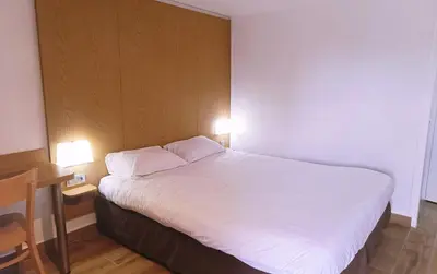 Un ou plusieurs lits dans un hébergement de l'établissement Kyriad ECO - Belfort Bessoncourt