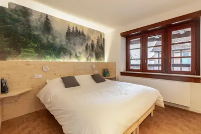 Un ou plusieurs lits dans un hébergement de l'établissement Chabi Cottage Gîte au coeur d'Eguisheim