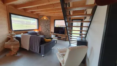 Coin salon dans l'établissement CHALET L'ÉCHAPPÉE NATURE 4 étoiles sauna