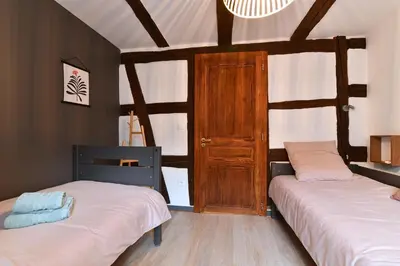 Un ou plusieurs lits dans un hébergement de l'établissement Grand gîte dans maison alsacienne historique