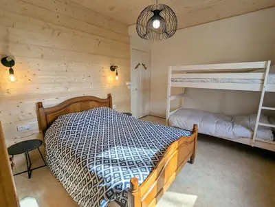 Un ou plusieurs lits dans un hébergement de l'établissement Appartement Chaleureux Gérardmer proche forêt