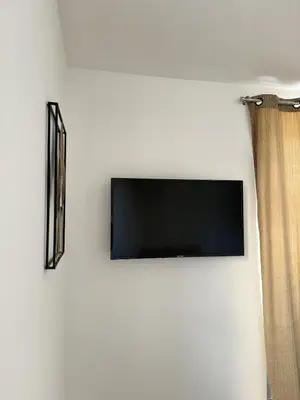 Télévision ou salle de divertissement dans l'établissement La Chambre Aux Anges
