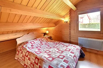 Un ou plusieurs lits dans un hébergement de l'établissement Chalet Charmilles - Chalet vue sur montagne