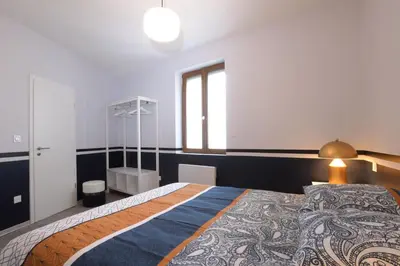Un ou plusieurs lits dans un hébergement de l'établissement Au Cheval Blanc - Appartement Familial 6P Parking privé proche Colmar Centre