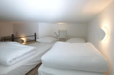 Un ou plusieurs lits dans un hébergement de l'établissement Au Cheval Blanc - Appartement Familial 6P Parking privé proche Colmar Centre