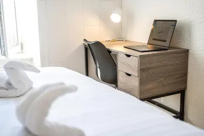 Un ou plusieurs lits dans un hébergement de l'établissement Le 42-GregIMMO-Appart'Hôtel