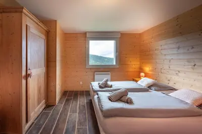 Un ou plusieurs lits dans un hébergement de l'établissement Chalet Dyna, luxe, calme et sérénité