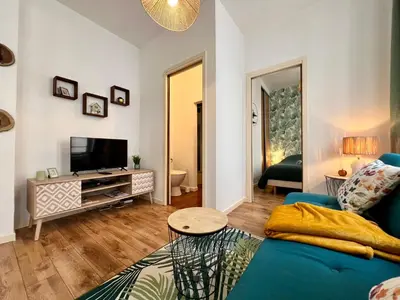 Télévision ou salle de divertissement dans l'établissement Le Petit Moulin