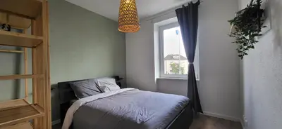 Un ou plusieurs lits dans un hébergement de l'établissement Appartement lumineux 2 chambres