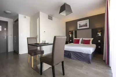 Un ou plusieurs lits dans un hébergement de l'établissement Appart'hôtel Odalys City - Colmar Centre