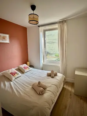 Un ou plusieurs lits dans un hébergement de l'établissement Charmant Appartement Mulhouse