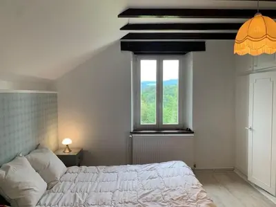 Un ou plusieurs lits dans un hébergement de l'établissement Gîte Au bout des Mynes avec vue panoramique