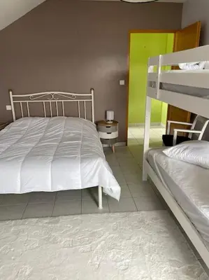 Un ou plusieurs lits dans un hébergement de l'établissement Maison avec jardin Gérardmer L'AUTOUR