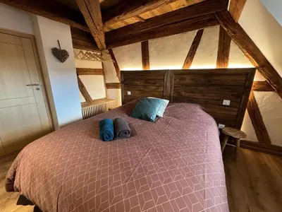 Un ou plusieurs lits dans un hébergement de l'établissement Gite Premium au grenier de l'Ours