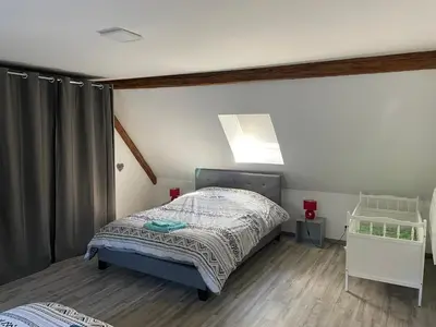 Un ou plusieurs lits dans un hébergement de l'établissement Gite chez l'Olivier