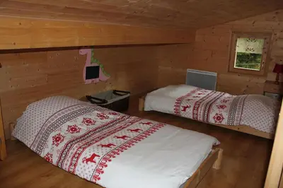 Un ou plusieurs lits dans un hébergement de l'établissement Chalet de la Lette