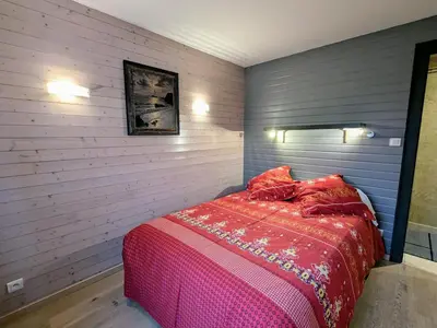 Un ou plusieurs lits dans un hébergement de l'établissement Gîte cosy au cœur de Gérardmer avec jardin et terrasse - FR-1-589-670
