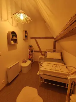 Un ou plusieurs lits dans un hébergement de l'établissement Charmante maison alsacienne, jardin et sauna