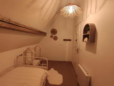 Un ou plusieurs lits dans un hébergement de l'établissement Charmante maison alsacienne, jardin et sauna