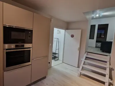 Cuisine ou kitchenette dans l'établissement Appartement Au petit bonheur