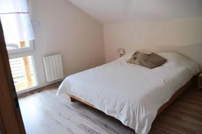 Un ou plusieurs lits dans un hébergement de l'établissement Chalet Au Cottage des Lynx