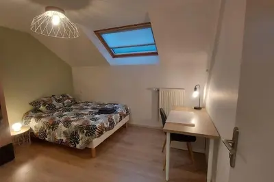 Un ou plusieurs lits dans un hébergement de l'établissement Maison La Belfort You proche TechnHom