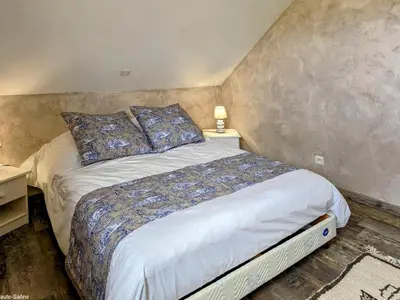 Un ou plusieurs lits dans un hébergement de l'établissement Maison charmante avec jardin, terrasse et parking près du Ballon d'Alsace - FR-1-583-297