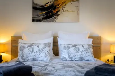 Un ou plusieurs lits dans un hébergement de l'établissement Maison cosy et bien située