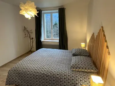 Un ou plusieurs lits dans un hébergement de l'établissement Naturel loft 5 personnes et jardin