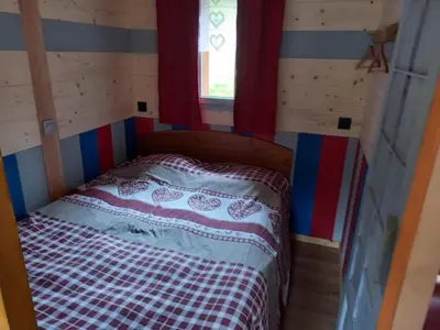 Un ou plusieurs lits dans un hébergement de l'établissement CHALET DU PERE NOEL 10 minutes from Gérardmer