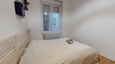 Un ou plusieurs lits dans un hébergement de l'établissement Le Majestic & Pool Mulhouse
